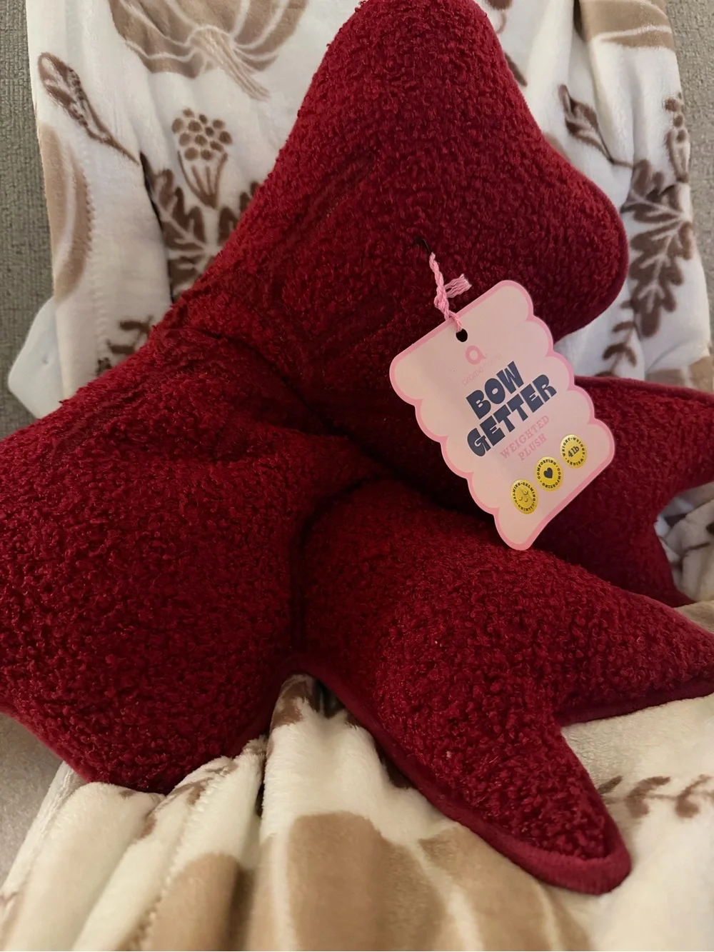 Burgundy bow-shaped cushion